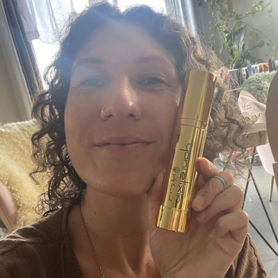 Customer holding her Yoni Elixir bottle